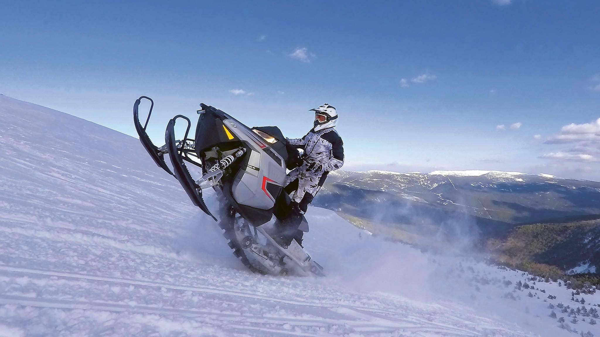 Snow jet ski runs over slope.